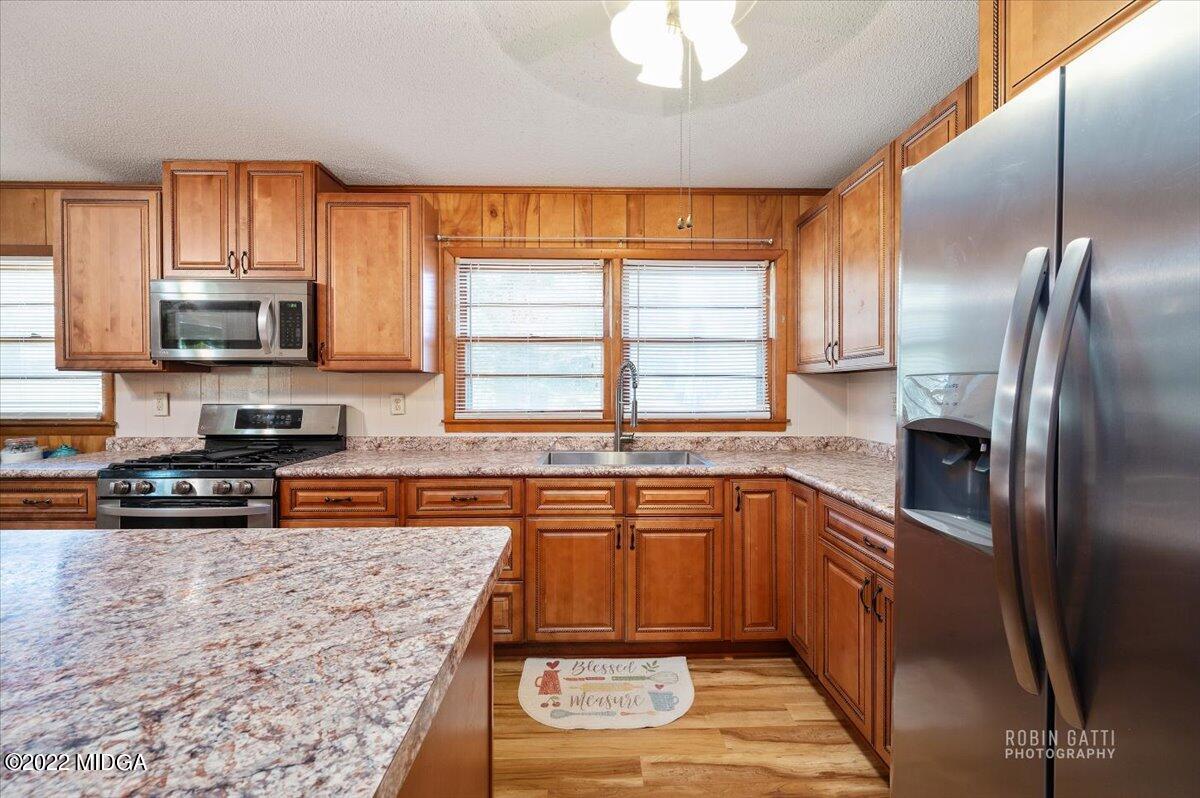 1979 Bonner Gilbert Road Macon, GA 31220 - Photo 8 of 35 a kitchen with stainless steel appliances granite countertop a sink stove microwave and refrigerator