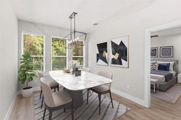 a view of a dining room with furniture window and wooden floor