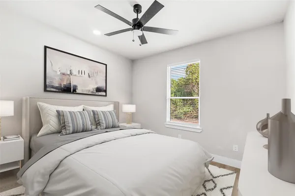 a bedroom with a large bed and a window