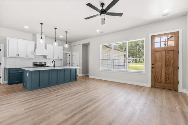 a view of kitchen with wooden floor and window