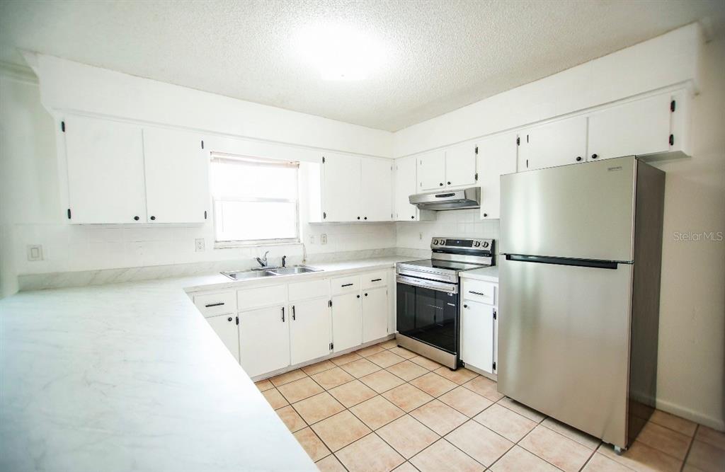 606 Water Road Ocala, FL 34472 - Photo 11 of 34 a kitchen with stainless steel appliances granite countertop a refrigerator sink and stove