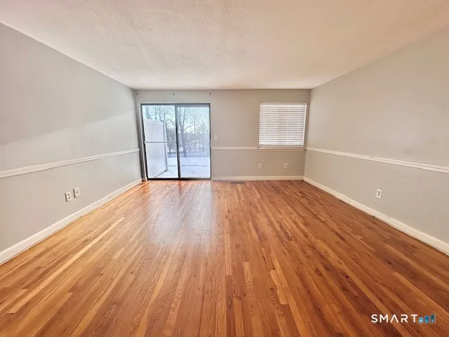 wooden floor in an empty room with a window