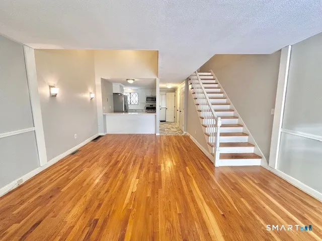 a view of a living room with wooden floor