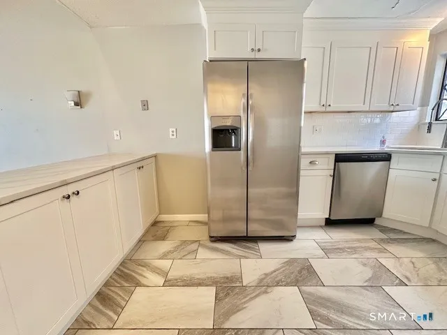 a refrigerator freezer sitting inside of a kitchen
