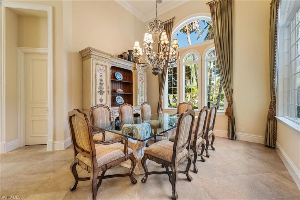 15299 Corsini Lane Naples, FL 34110 - Photo 14 of 40 a view of a dining room with furniture and a chandelier