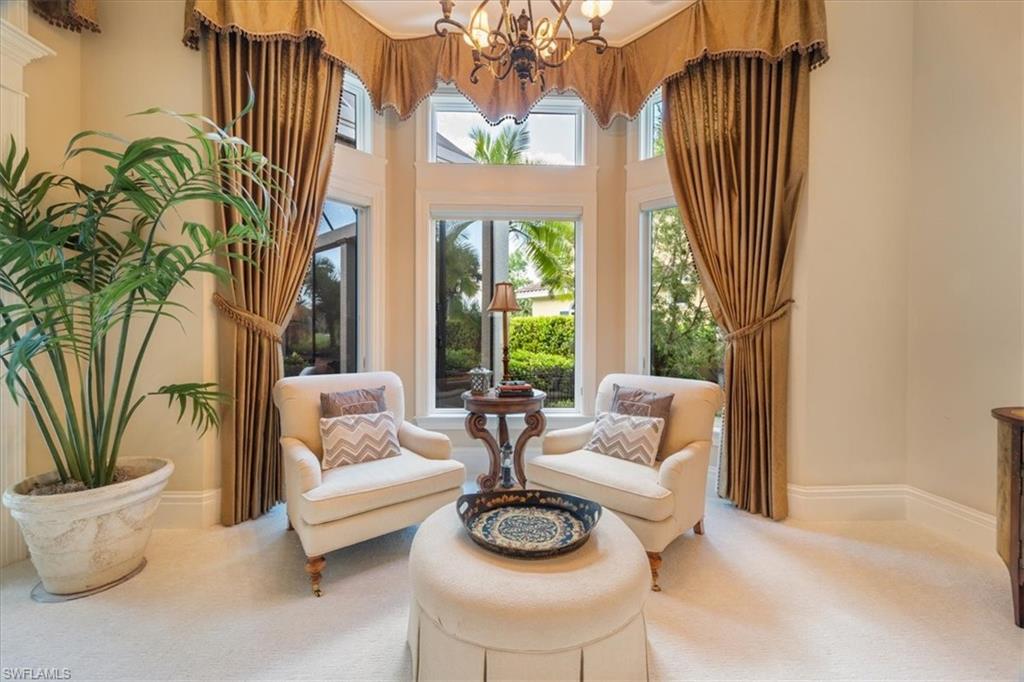 15299 Corsini Lane Naples, FL 34110 - Photo 16 of 40 a living room with furniture and a large window