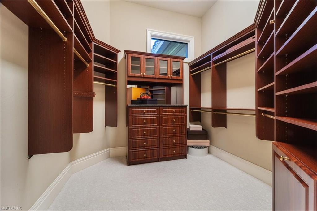 15299 Corsini Lane Naples, FL 34110 - Photo 17 of 40 a view of walk in closet with clothes