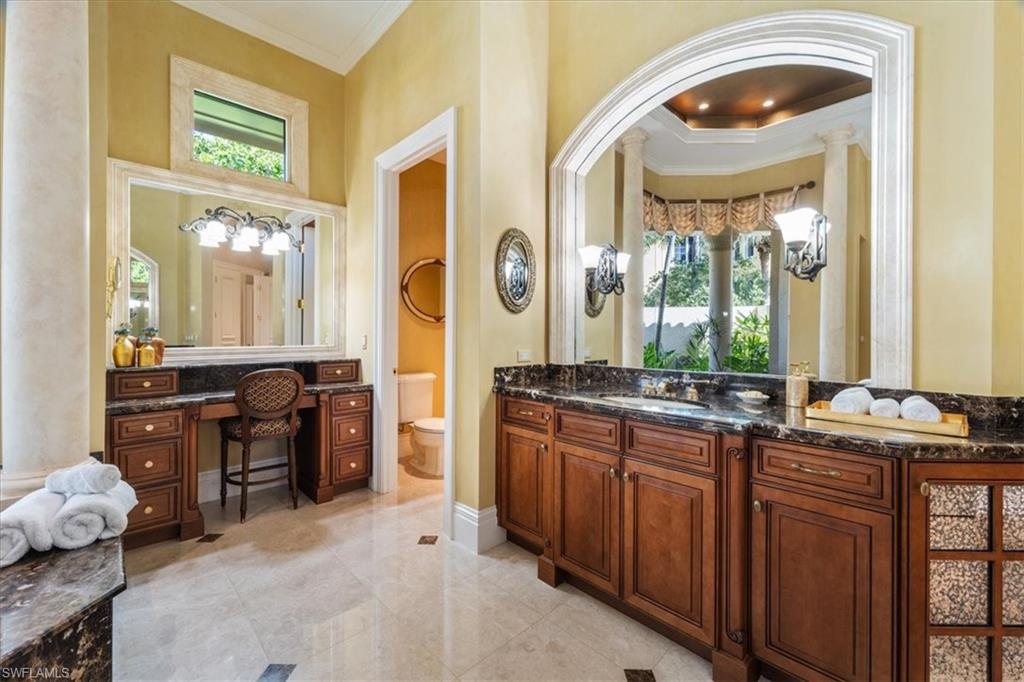 15299 Corsini Lane Naples, FL 34110 - Photo 20 of 40 a large bathroom with a large tub and sink