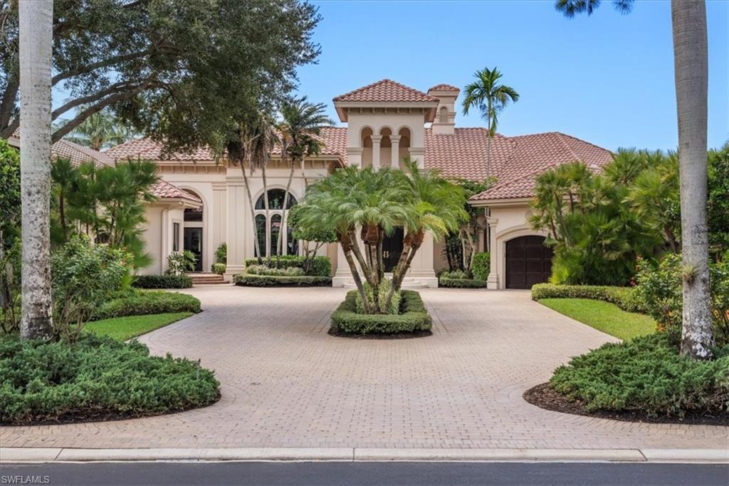 15299 Corsini Lane Naples, FL 34110 - Photo 2 of 40 a view of a white house with a yard and potted plants