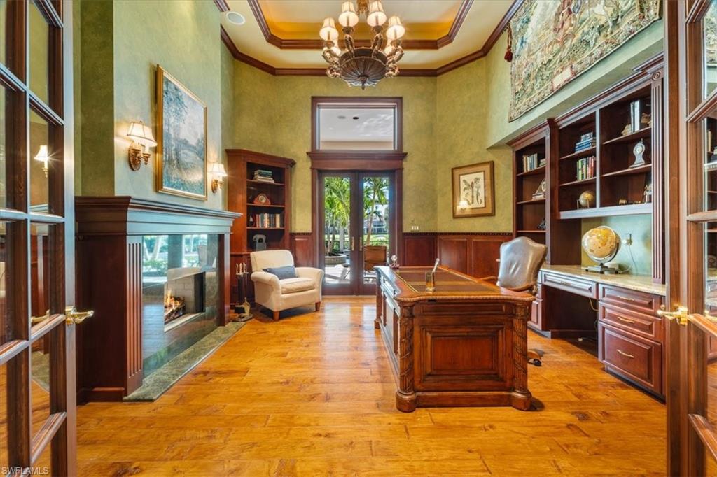 15299 Corsini Lane Naples, FL 34110 - Photo 22 of 40 a living room with fireplace furniture and a window