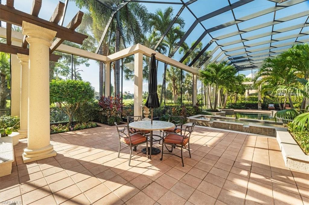 15299 Corsini Lane Naples, FL 34110 - Photo 27 of 40 a view of patio with table and chairs and potted plants