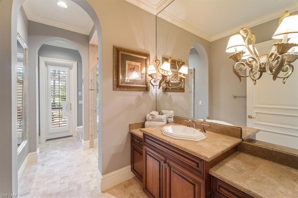 15299 Corsini Lane Naples, FL 34110 - Photo 30 of 40 a bathroom with a sink and a mirror
