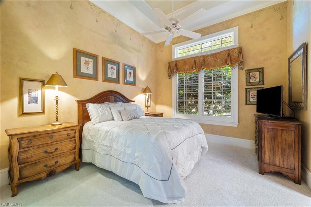 15299 Corsini Lane Naples, FL 34110 - Photo 31 of 40 a bedroom with a bed and a flat screen tv