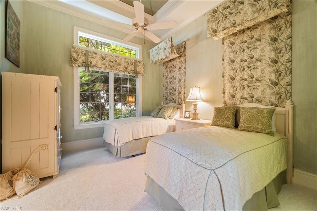 15299 Corsini Lane Naples, FL 34110 - Photo 32 of 40 a bedroom with a bed and a large window