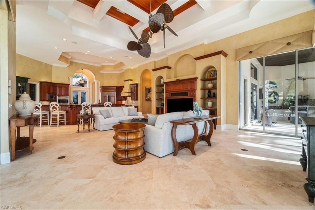 15299 Corsini Lane Naples, FL 34110 - Photo 10 of 40 a living room with lots of furniture and a chandelier