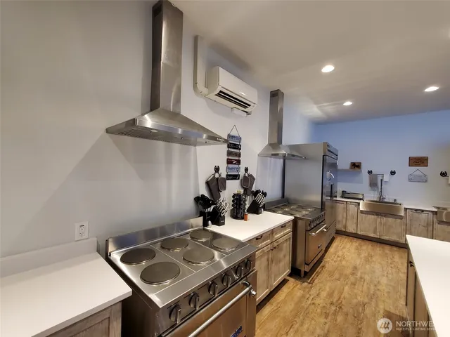 a kitchen with stainless steel appliances granite countertop a sink and cabinets