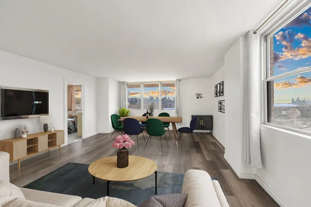 a living room with furniture a flat screen tv and a window
