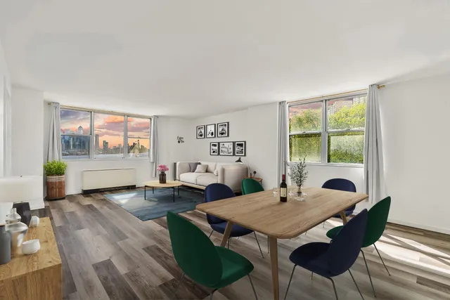 a view of a dining room with furniture a rug and wooden floor