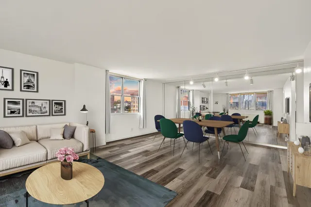 a living room with furniture and a dining table with wooden floor