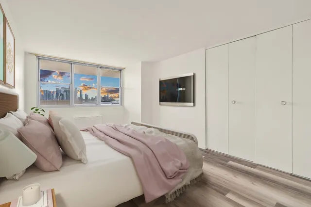 a bedroom with a bed and a television