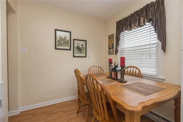 a dining room with furniture and wooden floor
