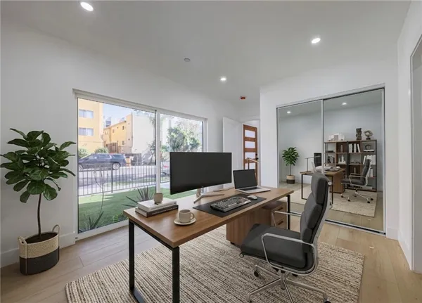 a view of a workspace with furniture and a potted plant