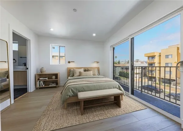a bedroom with a large bed and a large window