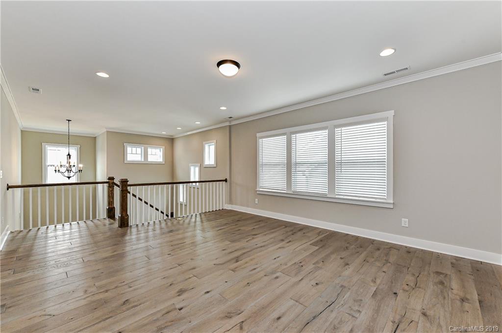 3072 Fish Story Court, Unit 360 Fort Mill, SC 29708 - Photo 14 of 27 a view of an empty room with wooden floor and a window