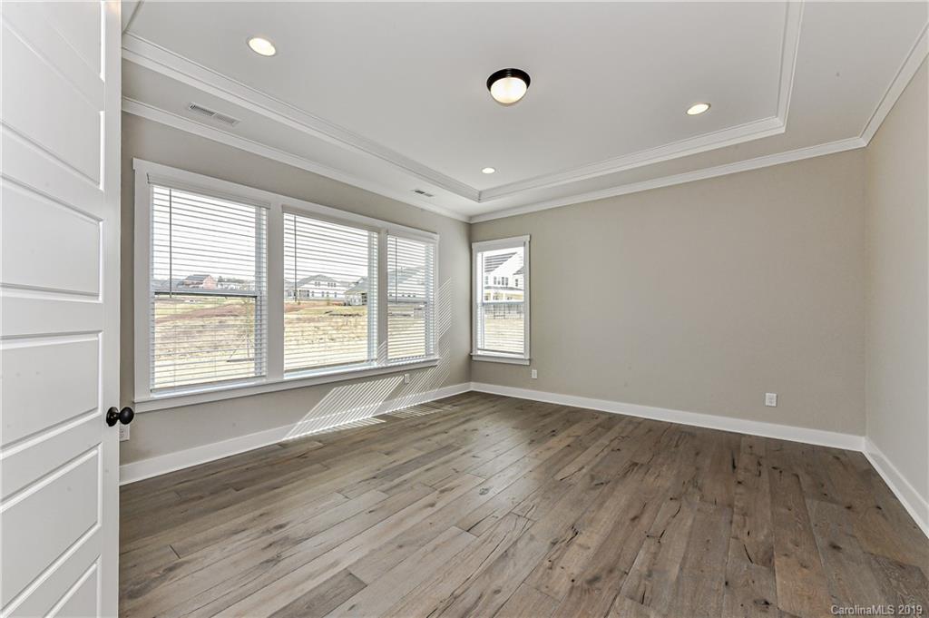 3072 Fish Story Court, Unit 360 Fort Mill, SC 29708 - Photo 8 of 27 a view of an empty room with wooden floor and a window