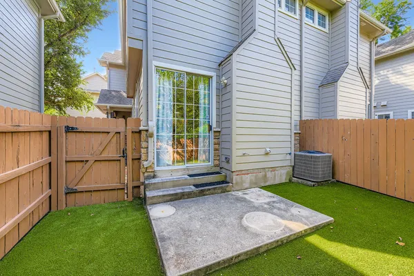 a front view of a house with a yard and potted plants