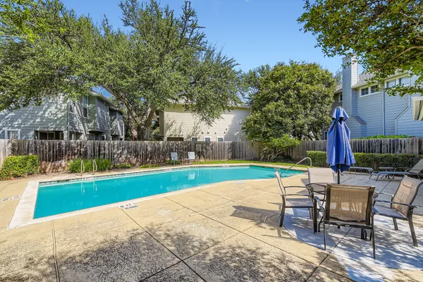 a view of a swimming pool with a patio and a garden
