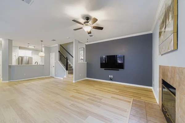 a view of a livingroom with a flat screen tv and kitchen view
