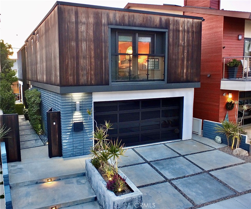 a view of a house with a small yard and wooden fence
