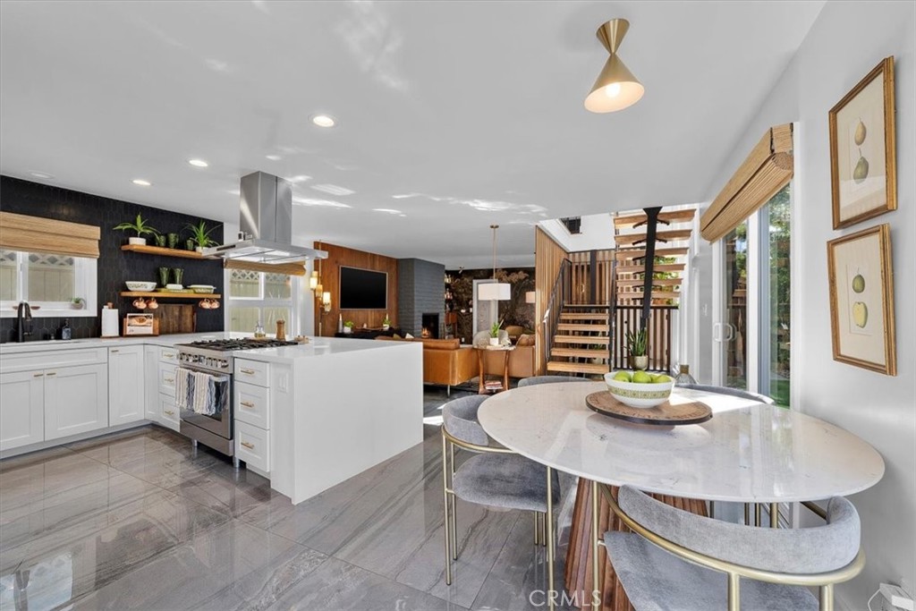 35 Geneva Walk Long Beach, CA 90803 - Photo 12 of 52 a kitchen with stainless steel appliances kitchen island granite countertop a sink and cabinets
