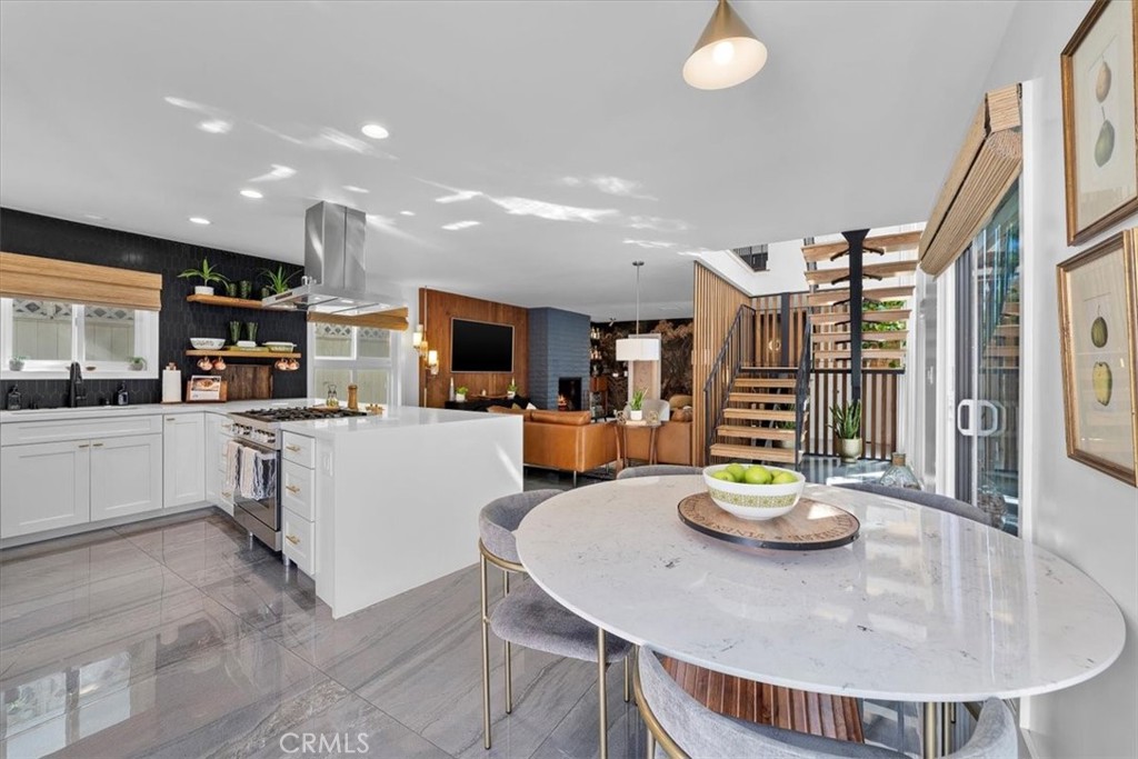 35 Geneva Walk Long Beach, CA 90803 - Photo 13 of 52 a kitchen with stainless steel appliances kitchen island granite countertop a sink and cabinets