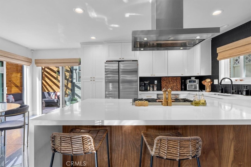 35 Geneva Walk Long Beach, CA 90803 - Photo 9 of 52 a kitchen with a sink a stove and chairs