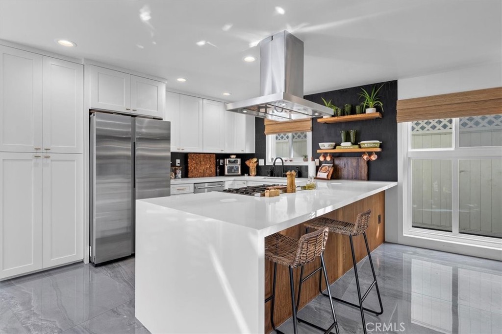 35 Geneva Walk Long Beach, CA 90803 - Photo 10 of 52 a kitchen with stainless steel appliances granite countertop a sink a stove a refrigerator and island with wooden floor