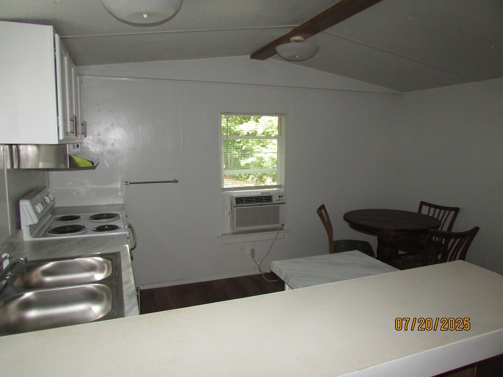 1444 Abe Cove Road Hiawassee, GA 30546 - Photo 20 of 25 a kitchen with a stove and a refrigerator