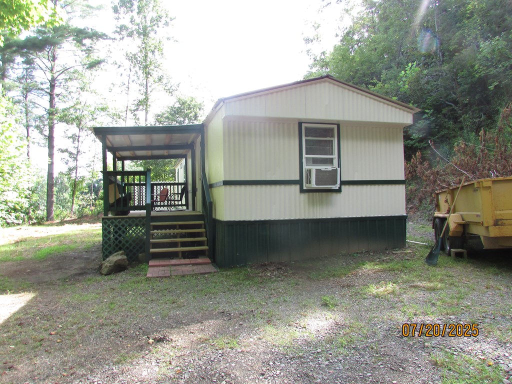 1444 Abe Cove Road Hiawassee, GA 30546 - Photo 3 of 25 a front view of a house with a yard