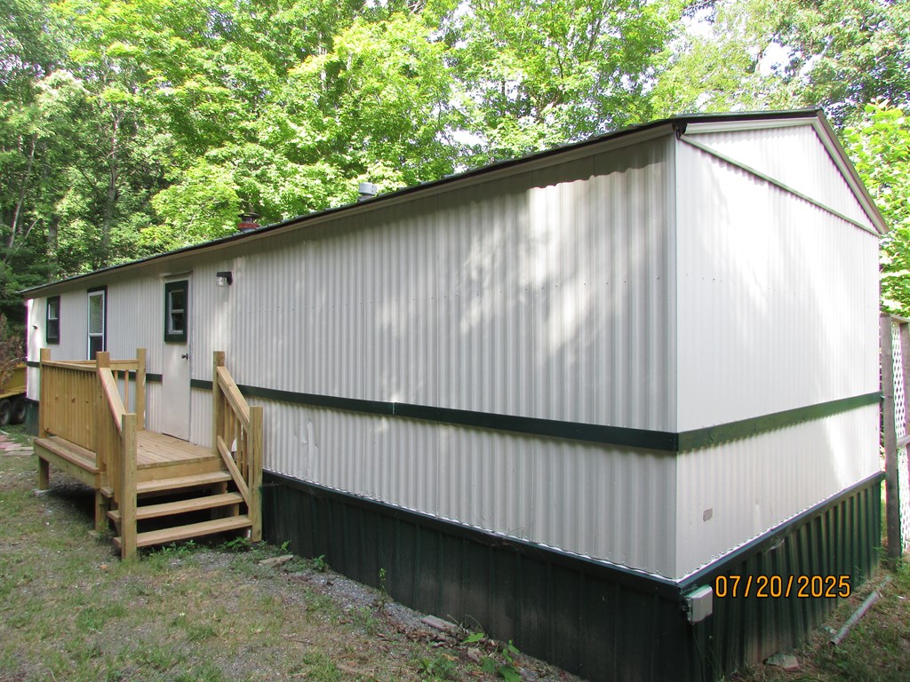 1444 Abe Cove Road Hiawassee, GA 30546 - Photo 5 of 25 a backyard of a house with wooden deck and furniture