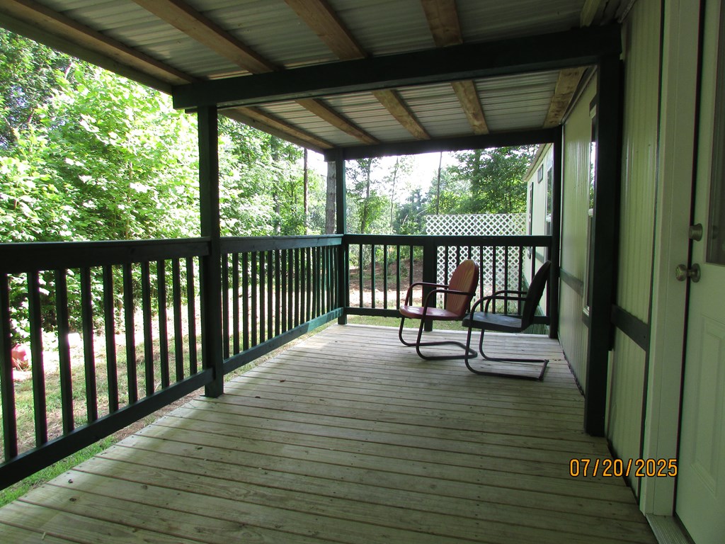 1444 Abe Cove Road Hiawassee, GA 30546 - Photo 7 of 25 a view of a balcony with chairs and wooden floor