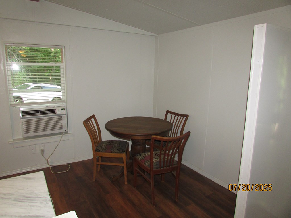 1444 Abe Cove Road Hiawassee, GA 30546 - Photo 9 of 25 a view of a dining room with furniture window and wooden floor