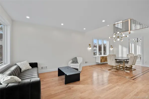 a living room with furniture and view of kitchen