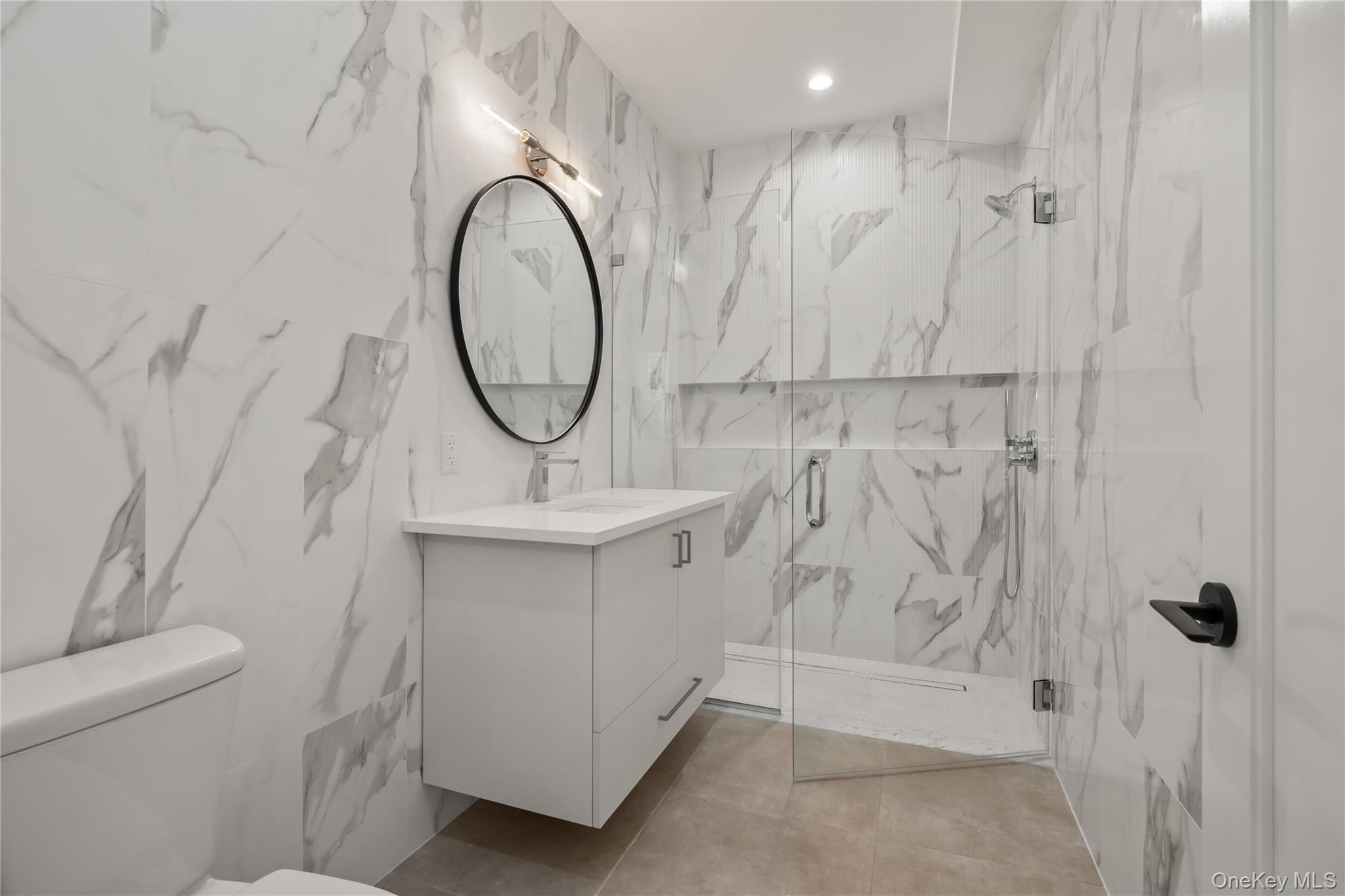 59 Dessau Circle Spring Valley, NY 10977 - Photo 31 of 48 a bathroom with a sink a toilet and a mirror