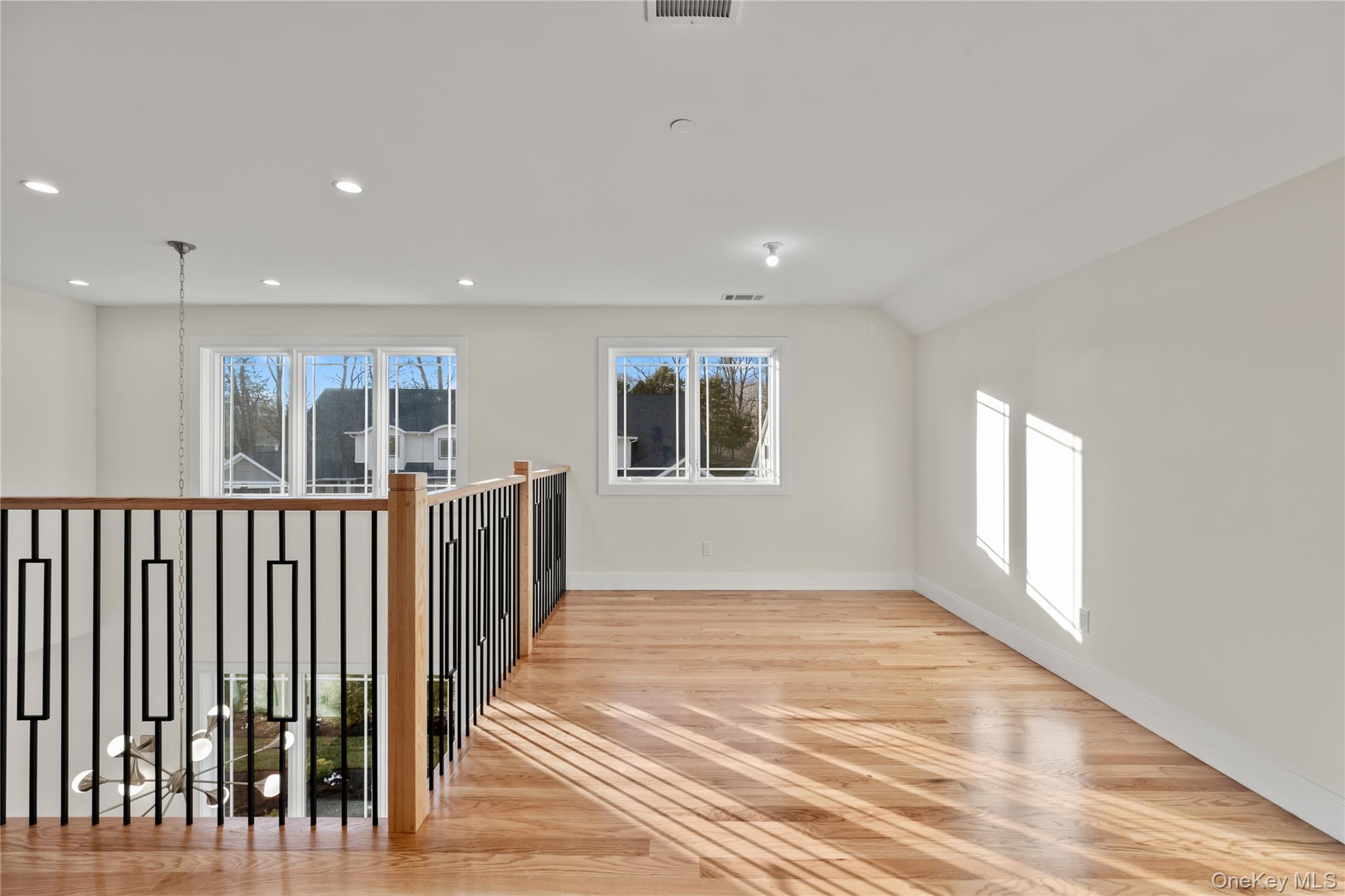 59 Dessau Circle Spring Valley, NY 10977 - Photo 36 of 48 an empty room with wooden floor and windows