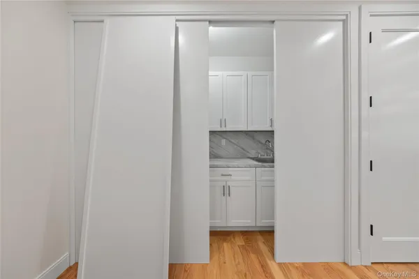 a room with a bench and wooden floor