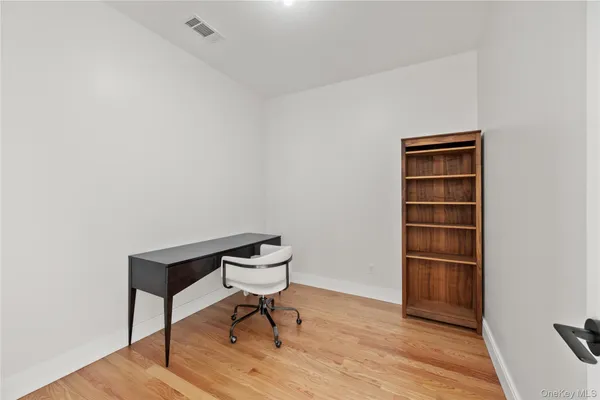 a bench sitting in a room next to a cabinet