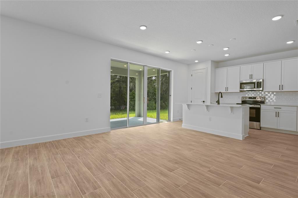 1026 Cloud Rdg Court Mount Dora, FL 32757 - Photo 8 of 20 a view of an empty room with wooden floor and a window