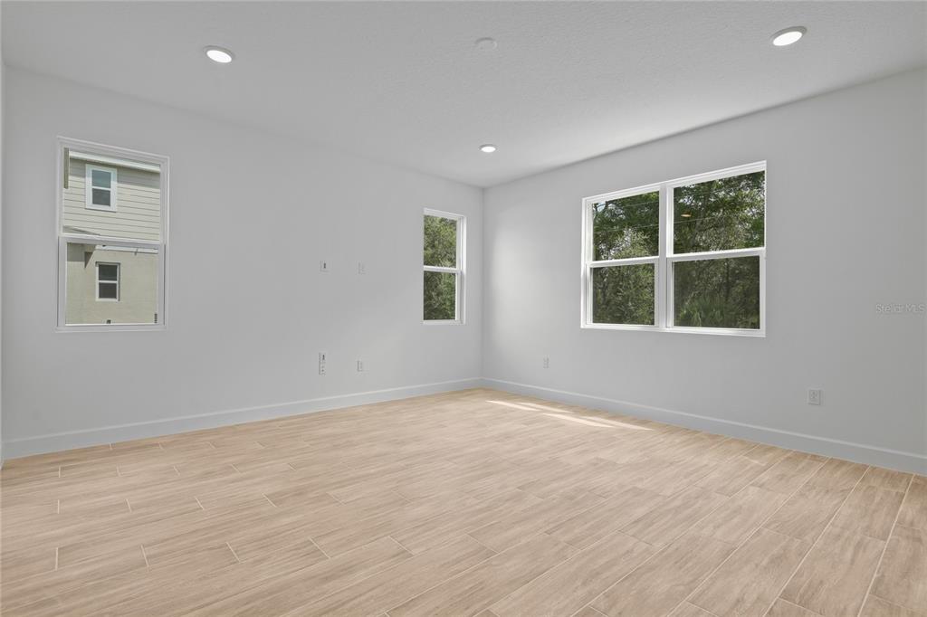 1026 Cloud Rdg Court Mount Dora, FL 32757 - Photo 9 of 20 a view of an empty room with wooden floor and a window