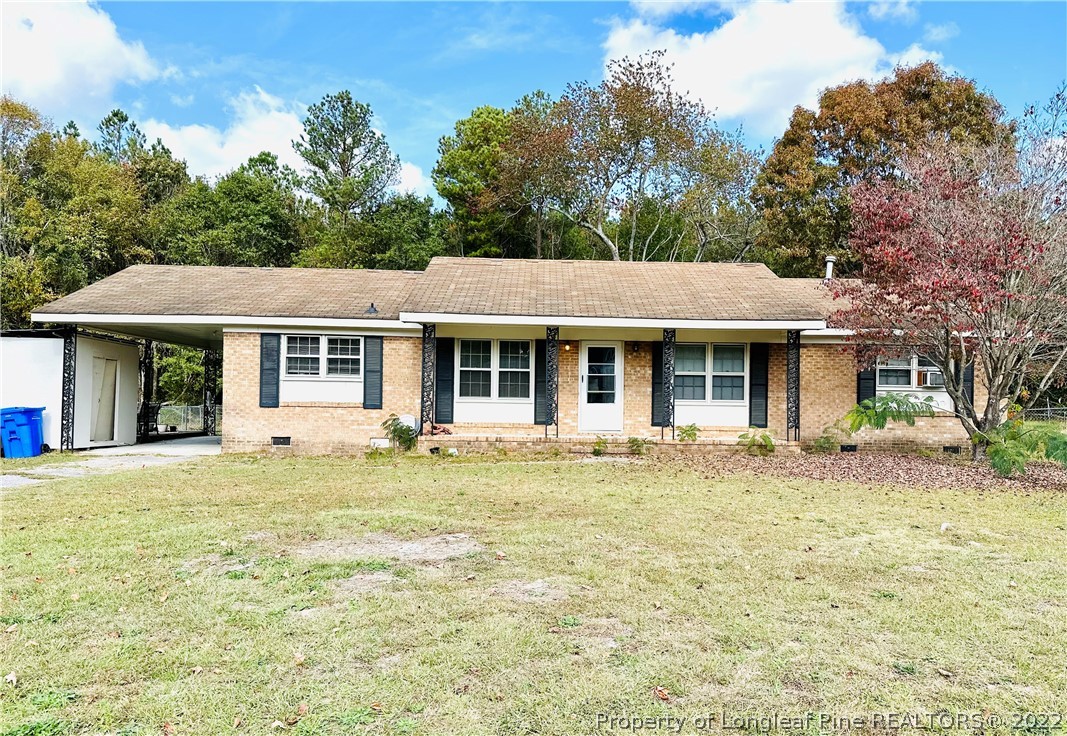 7405 Southgate Road Fayetteville, NC 28314 - Photo 1 of 16 a front view of a house with a garden